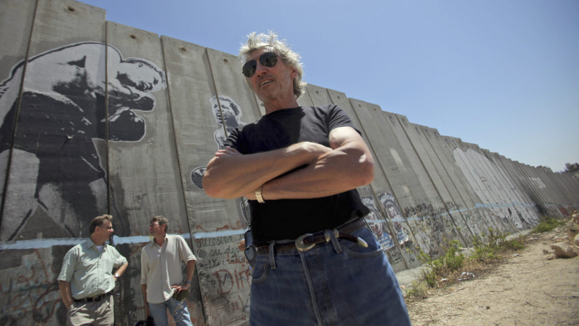Composer and former bassist and singer of British rock band Pink Floyd Roger Waters, is seen while touring Israel's apartheid wall in the West Bank refugee camp of Aida in Bethlehem, Tuesday, June 2, 2009. (AP/Muhammed Muheisen)
