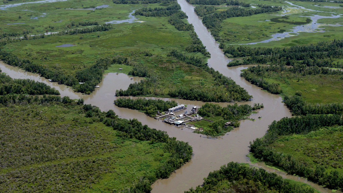 An oil facility is seen in the middle of canals dug for oil pipelines on the coast of Louisiana, Wednesday, July 28, 2010. (AP/Patrick Semansky)