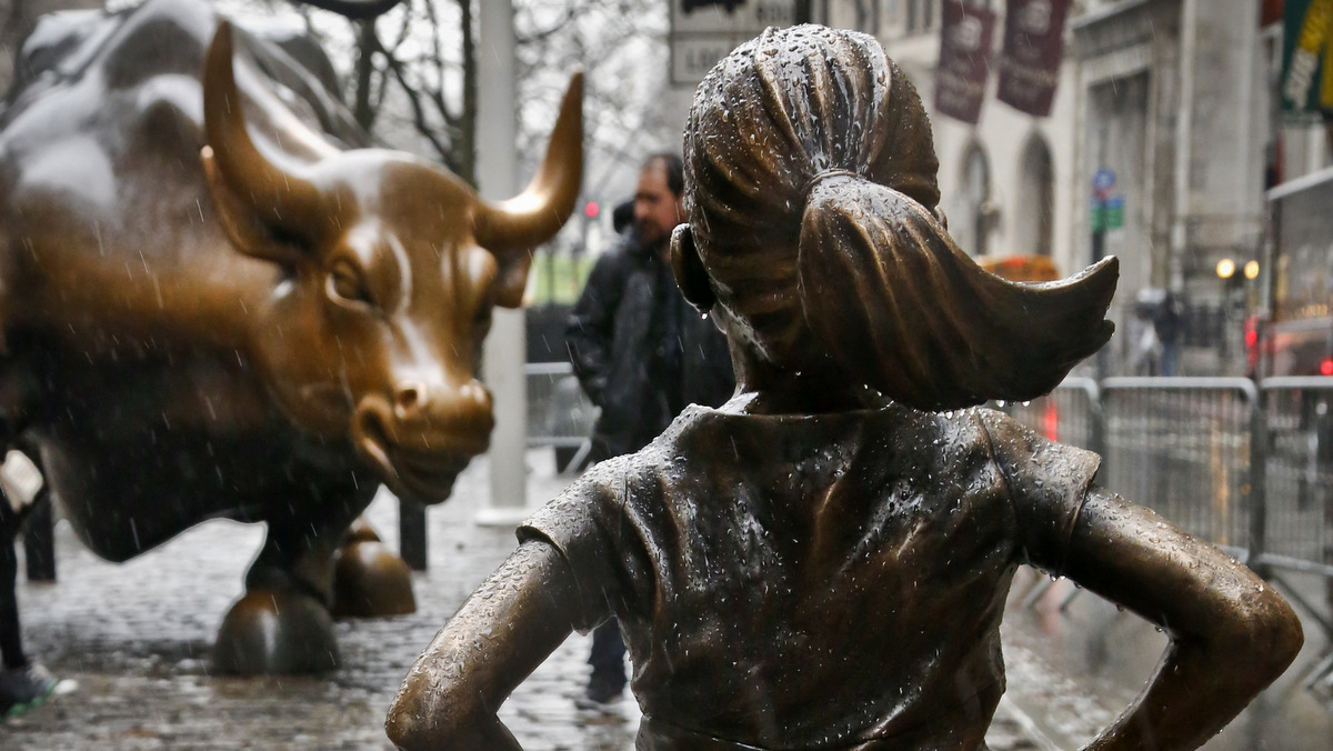 The "Fearless Girl" statue, created by Kristen Visbal, stands across from the "Charging Bull" statue, Monday, March 27, 2017, in New York. (AP/Bebeto Matthews)