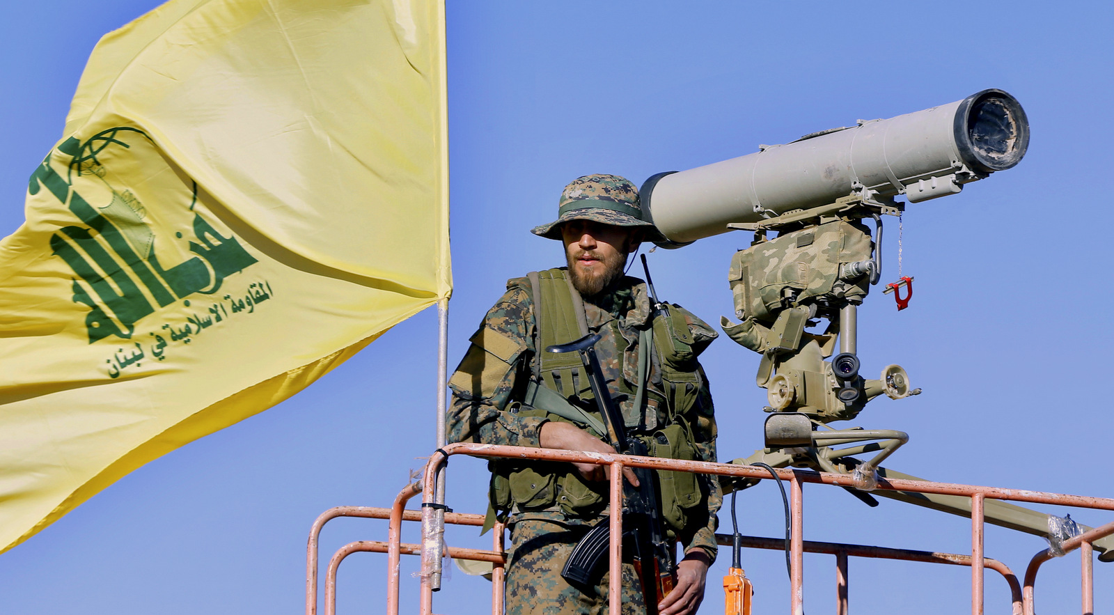 This Saturday, July 29, 2017 photo, a Hezbollah fighter stands at a watchtower at the site where clashes erupted between Hezbollah and al-Qaida-linked fighters in Wadi al-Kheil or al-Kheil Valley in the Lebanon-Syria border. (AP/Bilal Hussein)