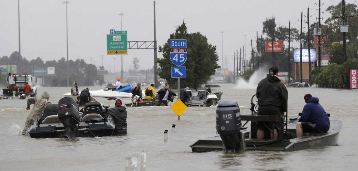 Volunteer rescue boats make their way into a flooded subdivision to rescue stranded residents as floodwaters from Tropical Storm Harvey rise Monday, Aug. 28, 2017, in Spring, Texas. (AP/David J. Phillip)