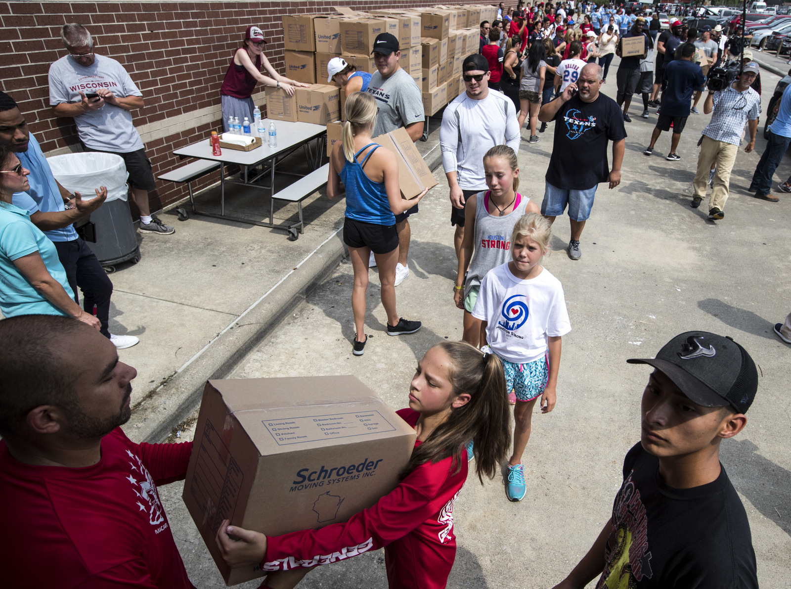 Volunteers unload a truck of relief supplies for people impacted by Hurricane Harvey on Sunday, Sept. 3, 2017, in Houston. J.J. Watt's Hurricane Harvey Relief Fund has raised millions of dollars to help those affected by the storm. (Brett Coomer/Houston Chronicle via AP)