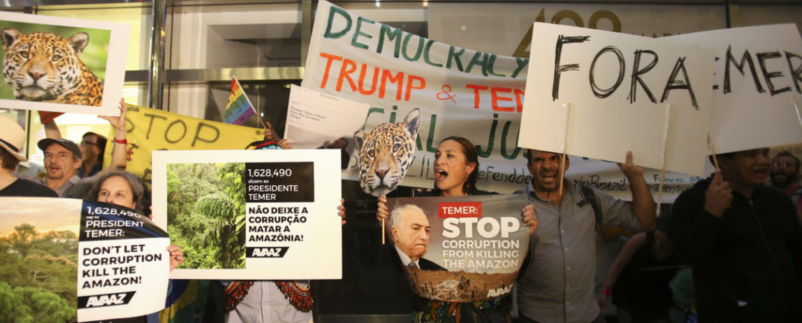 Brazilian residents and Amazon indigenous leaders protest Brazil's president Michel Temer, outside New York's Palace Hotel while he dines with US president Donald Trump on September 18, 2017 in New York. Temer is mired in corruption scandals, and is under fire for measures that environmentalists say are an attack on the Amazon rainforest. (Bennett Raglin/AP for AVAAZ)