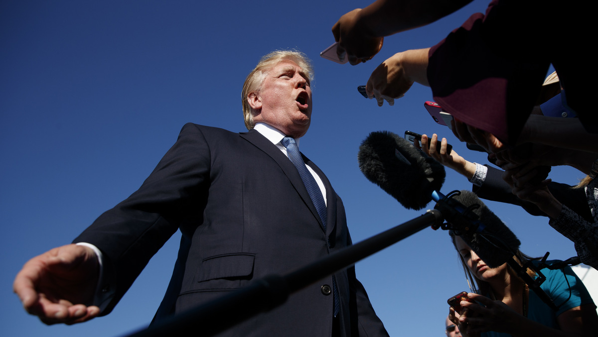 In this Sunday, Sept. 24, 2017, file photo, President Donald Trump speaks with reporters before boarding Air Force One at Morristown Municipal airport, in Morristown, N.J. The Trump administration announced new travel ban restrictions after spending months hashing out the details determined to avoid a repeat of the chaos of Trump’s first travel ban. (AP/Evan Vucci)