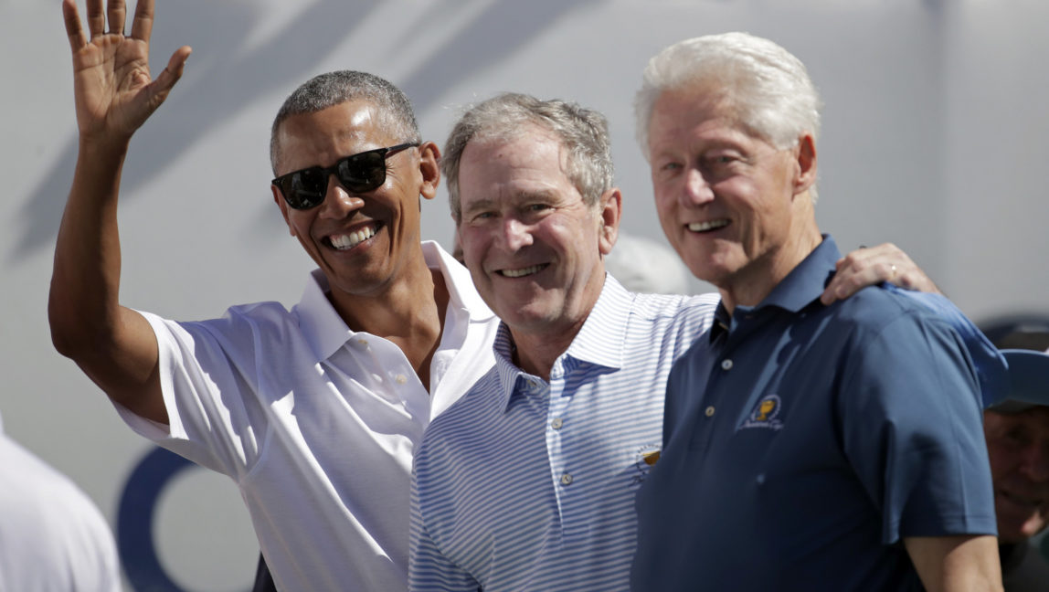 Former U.S. Presidents, from left, Barack Obama, George Bush and Bill Clinton greet spectators on the first tee before the first round of the Presidents Cup at Liberty National Golf Club in Jersey City, N.J., Sept. 28, 2017. (AP/Julio Cortez)