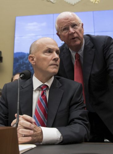 Former chairman and CEO of Equifax Richard F. Smith, talks with former Sen. Saxby Chambliss, R-Ga., as he takes his seat to testify before the Digital Commerce and Consumer Protection Subcommittee of the House Commerce Committee on Capitol Hill in Washington, Tuesday, Oct. 3, 2017. AP/Carolyn Kaster)