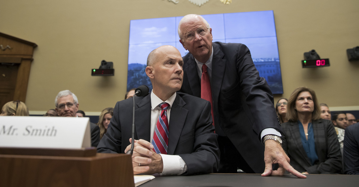 Former chairman and CEO of Equifax Richard F. Smith, talks with former Sen. Saxby Chambliss, R-Ga., as he takes his seat to testify before the Digital Commerce and Consumer Protection Subcommittee of the House Commerce Committee on Capitol Hill in Washington, Tuesday, Oct. 3, 2017. AP/Carolyn Kaster)