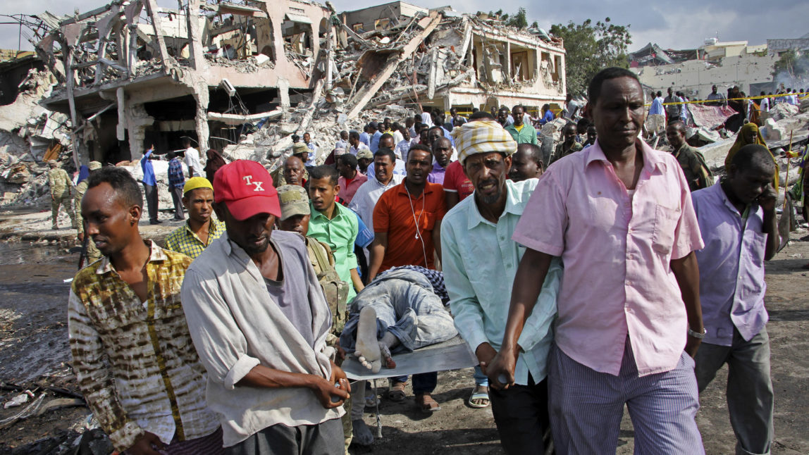 Somalis remove the body of a man killed in Saturday's blast, in Mogadishu, Somalia Sunday, Oct. 15, 2017. The death toll from the huge truck bomb blast in Somalia's capital rose to over 50 Sunday, with more than 60 others injured, as hospitals struggled to cope with the high number of casualties, security and medical sources said. (AP/Farah Abdi Warsameh)