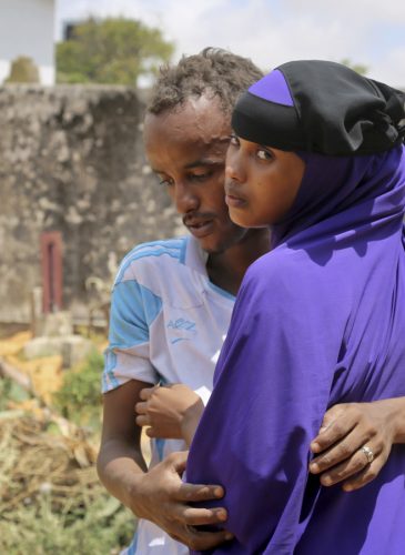 Zakariye Abdirisaq, left, who lost both his father and aunt in the bombing, is comforted by his cousin as they stand next to his father's grave, at a cemetery in Mogadishu, Somalia Tuesday, Oct. 17, 2017. Anguished families gathered across Somalia's capital on Tuesday as funerals continued for the more than 300 people killed in one of the world's deadliest attacks in years, while others waited anxiously for any word of the scores of people still said to be missing. (AP/Mohamed Sheikh Nor)