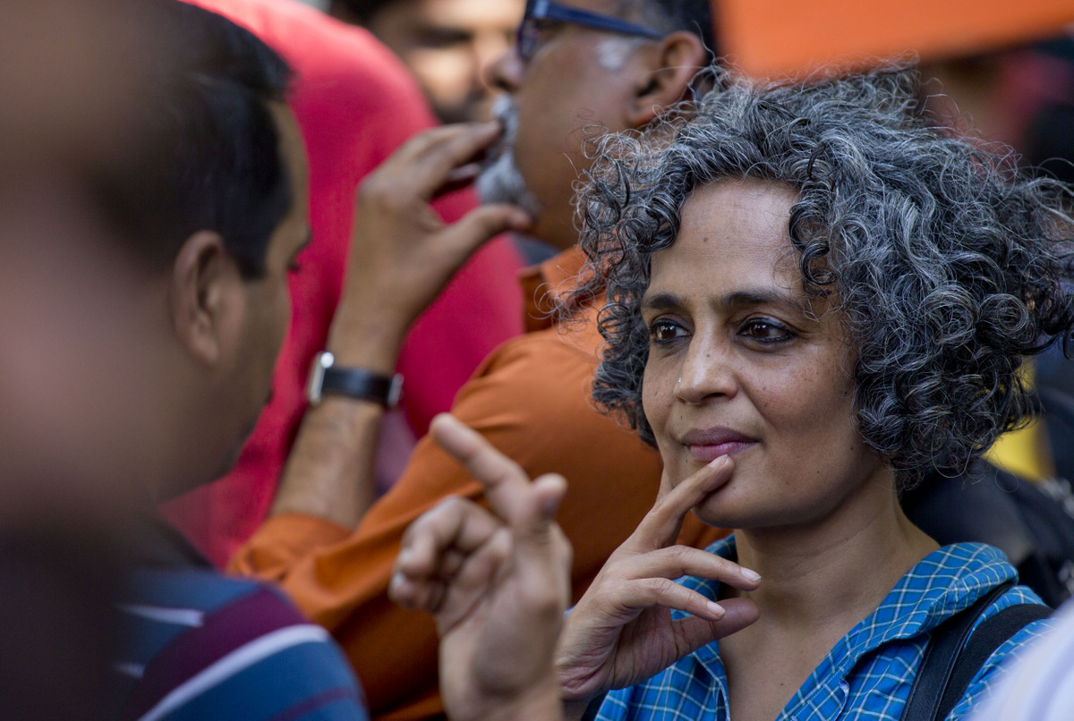Writer and activist Arundhati Roy right, talks to a student during a march to the Indian parliament house in New Delhi, India, Tuesday, 15 March 2016. (AP/Manish Swarup)