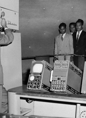 Six tribesmen from remote Pacific Islands are televised at the Museum of Science and Industry exhibit where they can see themselves in Chicago on April 7, 1957. The six were exposed to radioactive fallouts from the 1954 hydrogen explosion at Bikini, and have been brought to Chicago for tests. (AP Photo/EM)
