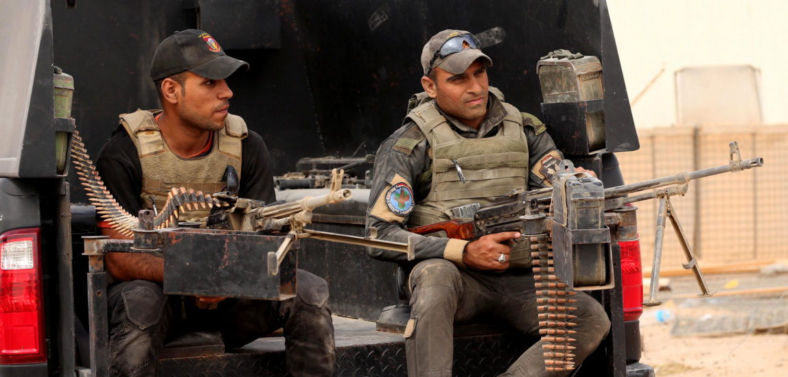 Iraqi soldiers guard a graduation ceremony of Sunni tribal volunteers joining Iraqi security forces in the town of Amiriyat al-Fallujah, west of Baghdad, Iraq, Friday, May 8, 2015. (AP/Hadi Mizban)