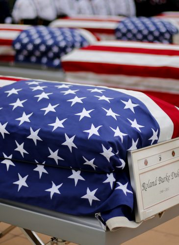 The flag draped casket of Roland Burke Dukes is shown during a memorial service and burial at Great Lakes National Cemetery in Holly Township, Mich., Thursday, Sept. 11, 2014. Thirteen military veterans whose remains went unclaimed at a Detroit morgue finally have been laid to rest. (AP Photo/Paul Sancya)