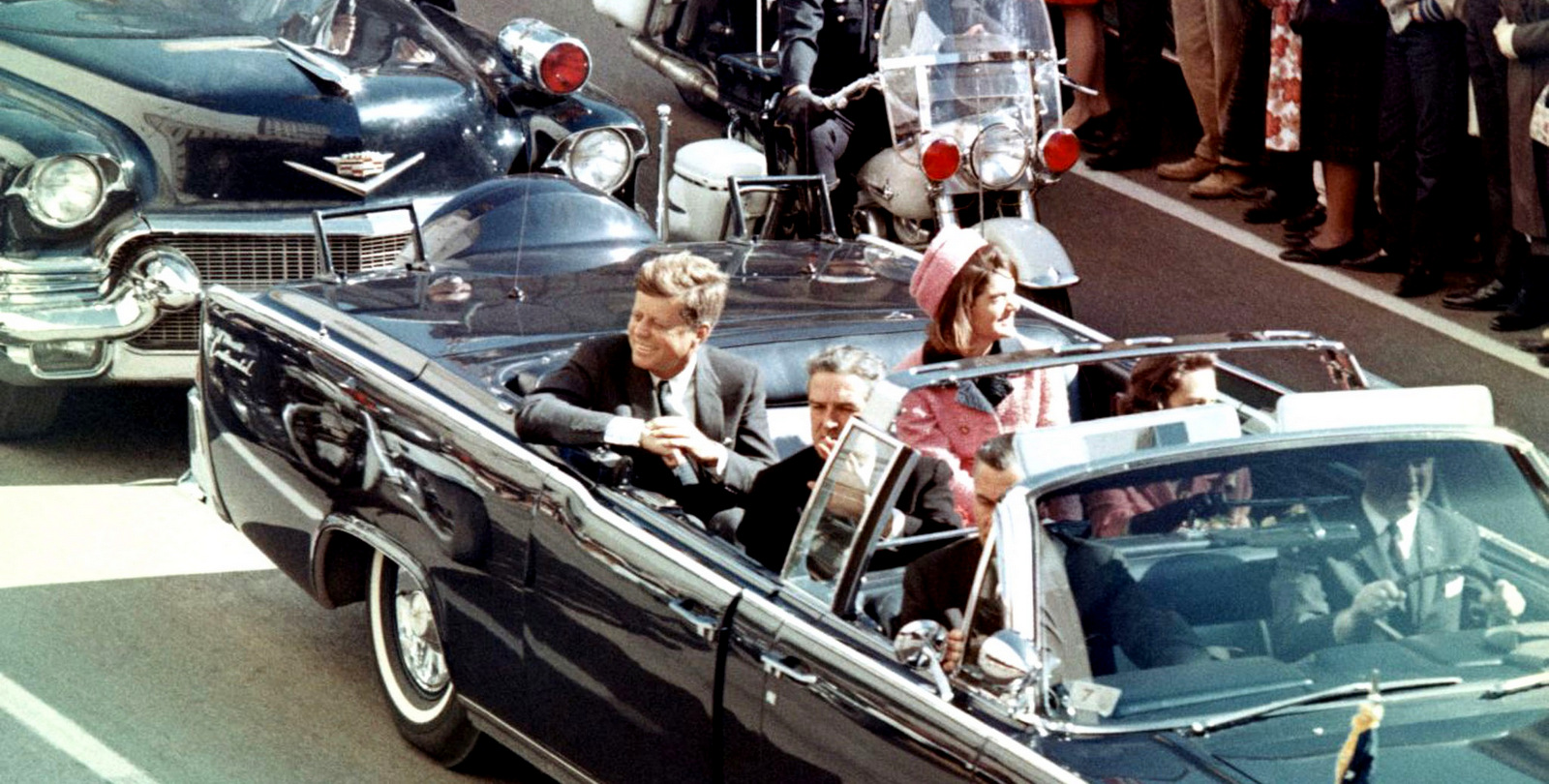 Picture of President Kennedy in the limousine in Dallas, Texas, on Main Street, minutes before the assassination. Also in the presidential limousine are Jackie Kennedy, Texas Governor John Connally, and his wife, Nellie.