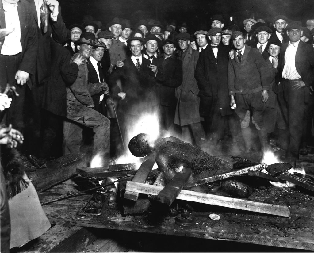 A group of white men pose for a 1919 photograph as they stand over the black victim Will Brown who had been lynched and had his body mutilated and burned during the Omaha race riot of 1919 in Omaha, Nebraska. Photographs and postcards of lynchings were popular souvenirs in the U.S.