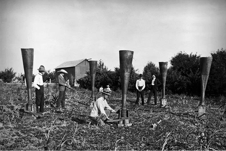 During the 1890s some theorized that smoke particles blown into the clouds would precipitate rain. These men appear to be trying that process. (Photo: Nebraska State Historical Society)