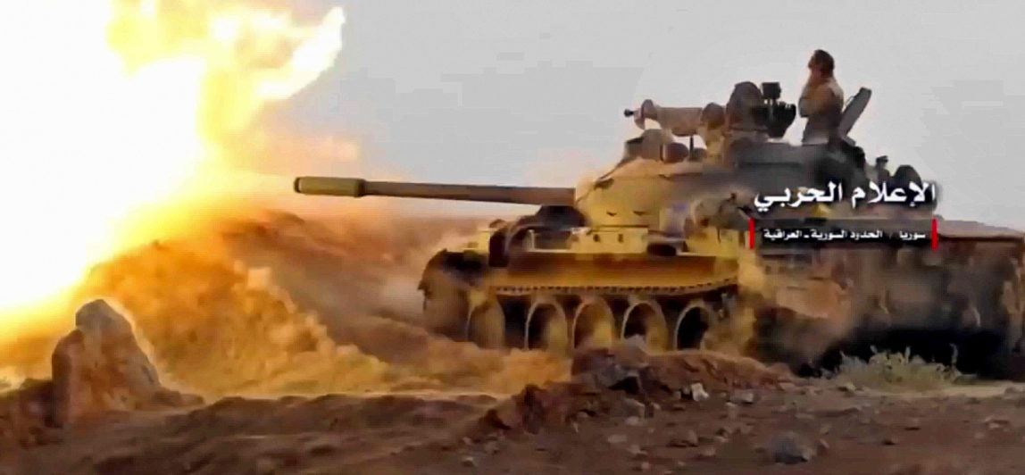 This frame grab from video provided, Nov 8, 2017, by the Syrian Central Military Media, shows a tank firing on militants' positions on the Iraq-Syria border. (Syrian Central Military/AP)