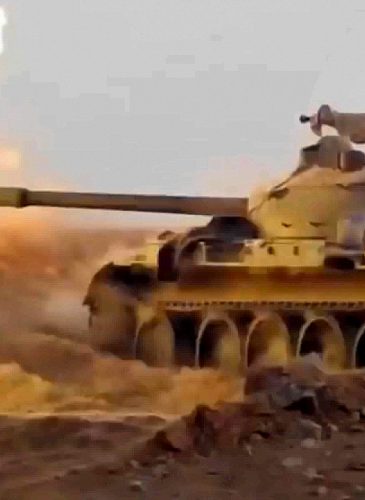 This frame grab from video provided, Nov 8, 2017, by the Syrian Central Military Media, shows a tank firing on militants' positions on the Iraq-Syria border. (Syrian Central Military/AP)