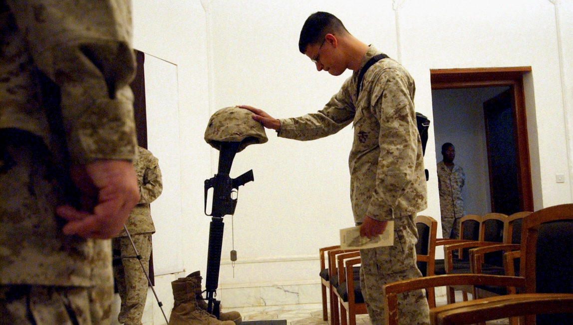 U.S. Marines pay their final respects at a memorial service for 1st Marine Division Combat Photographer Cpl. William Salazar, 26, of Las Vegas, NV, at Camp Blue Diamond, on the outskirts of Ramadi, Iraq, Monday, Oct. 18, 2004. (AP/Jim MacMillan)