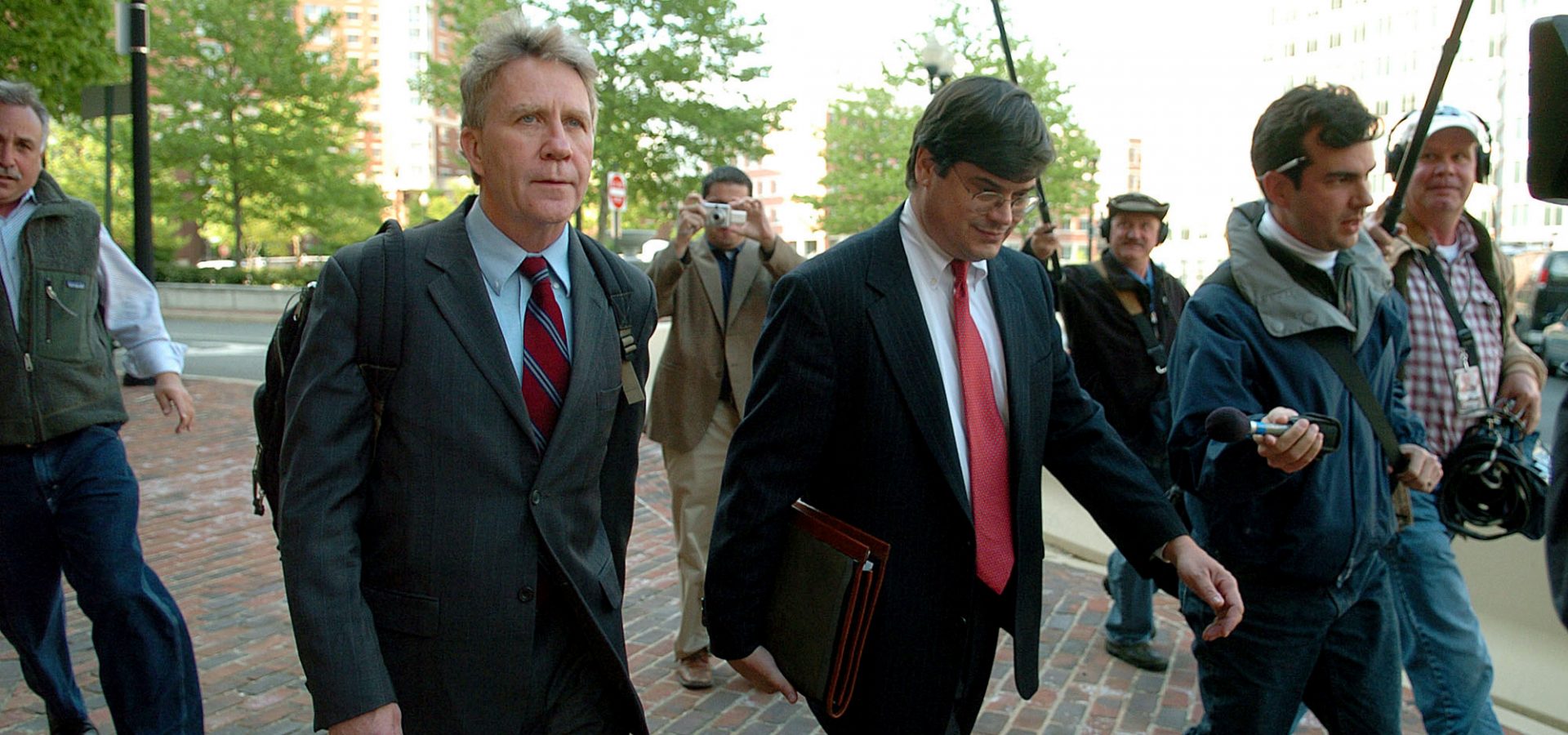 Larry Franklin, of Kearneysville, W.Va., left, leaves the federal courthouse in Alexandria, Va. after a hearing on Wednesday, May 4, 2005. The FBI arrested Franklin, a Pentagon analyst on a charge alleging he passed classified information about potential attacks against U.S. forces in Iraq to employees of a pro-Israel group. (AP/Kevin Wolf)