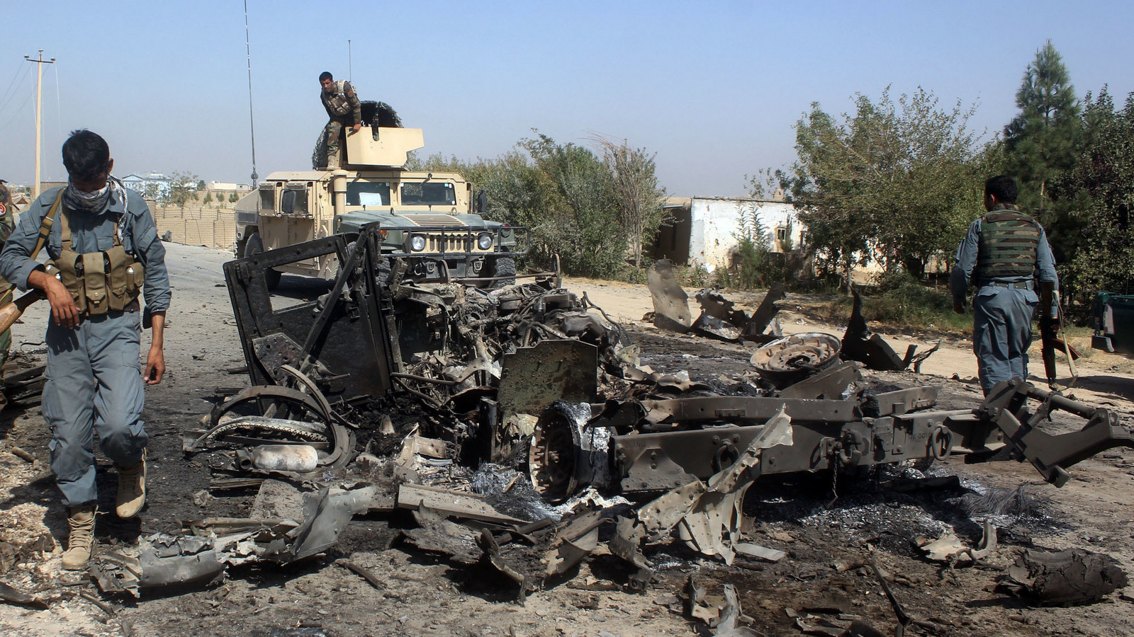 In this Oct. 2, 2015 file photo, Afghan security forces inspect the site of a U.S. airstrike in Kunduz city, north of Kabul, Afghanistan. (AP Photo)