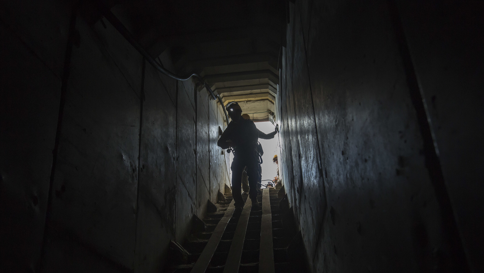 Israeli soldiers from the Home Front Command enter a tunnel, to attend to a soldier acting as a survivor in the smoke and rubble, during an army drill near the Israel Gaza border, Nov. 7, 2016. (AP/Tsafrir Abayov)