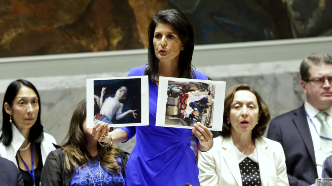 Nikki Haley, United States' Ambassador United Nations, shows pictures of Syrian victims of chemical attacks as she addresses a meeting of the Security Council on Syria at U.N. headquarters, April 5, 2017. (AP/Bebeto Matthews)