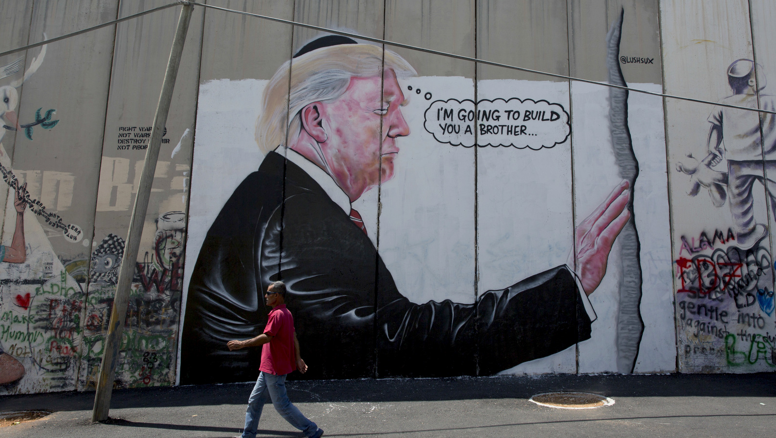 A mural resembling the work of elusive artist Banksy depicting President Donald Trump wearing a Jewish skullcap, is seen on Israel's West Bank apartheid wall in the West Bank city of Bethlehem, Aug. 4, 2017. (AP/Nasser Nasser)