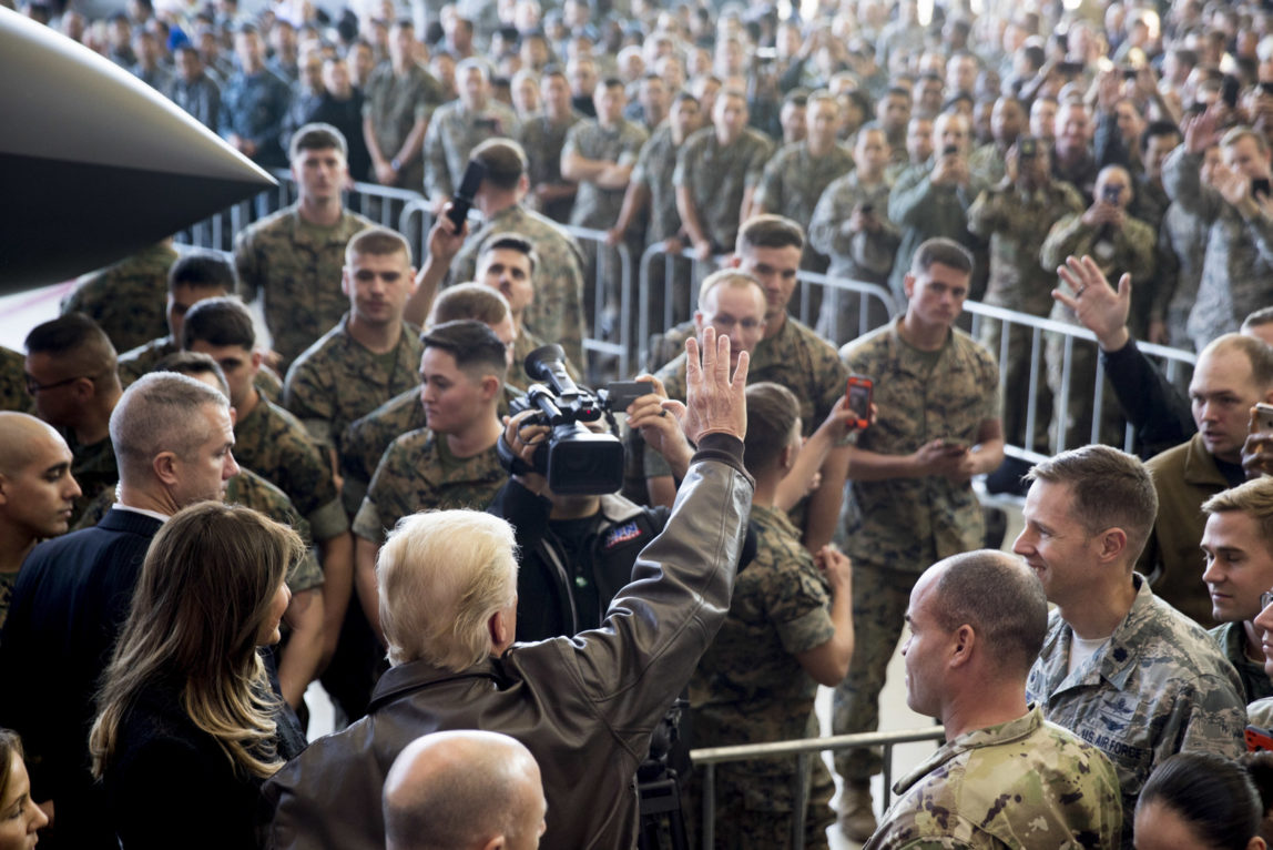 President Donald Trump, accompanied by first lady Melania Trump, left, waves to the crowd of members of the military as he speaks at a hanger rally at Yokota Air Base, Nov. 5, 2017, in Fussa, on the outskirts of Japan. (AP/Andrew Harnik)
