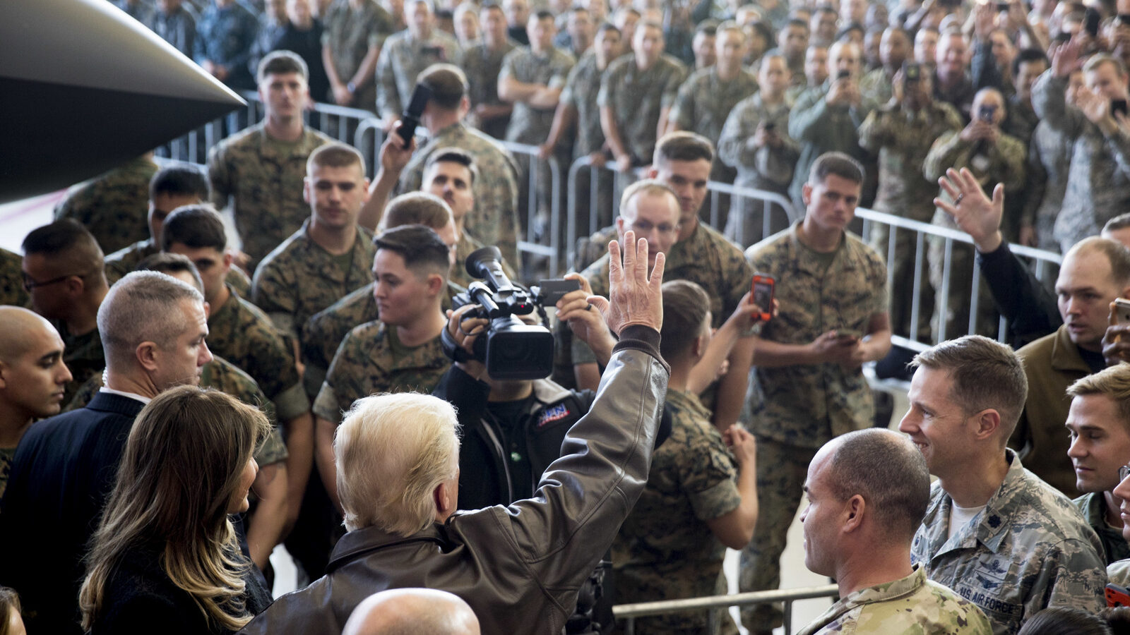 President Donald Trump, accompanied by first lady Melania Trump, left, waves to the crowd of members of the military as he speaks at a hanger rally at Yokota Air Base, Nov. 5, 2017, in Fussa, on the outskirts of Japan. (AP/Andrew Harnik)