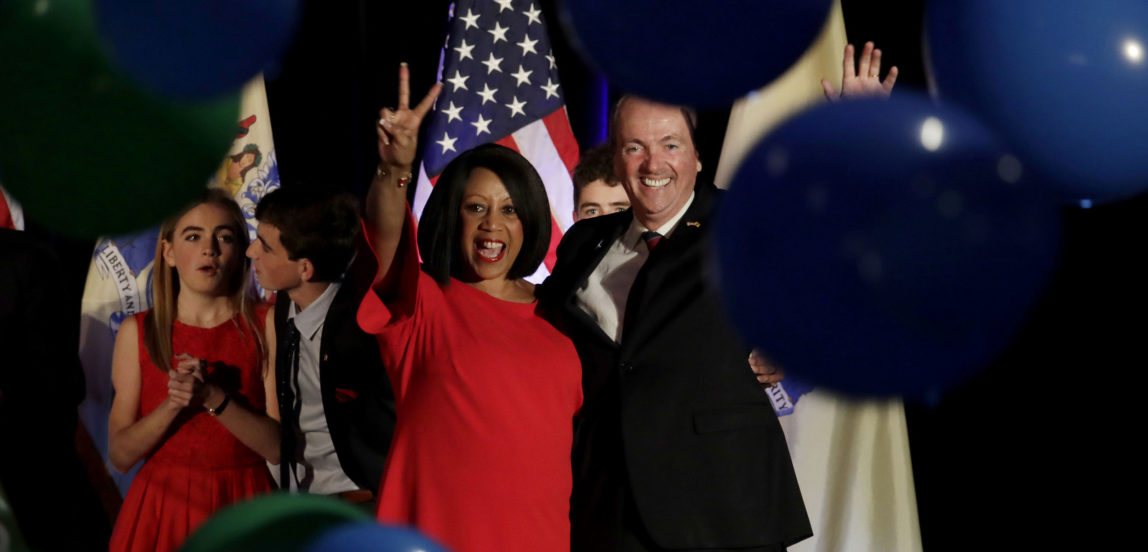 New Jersey gubernatorial nominee Phil Murphy, right, and Lt. Gov. nominee Sheila Oliver wave to supporters as balloons drop during their election night victory party at the Asbury Park Convention Hall, Tuesday, Nov. 7, 2017, in Asbury Park, N.J. (AP/Julio Cortez)