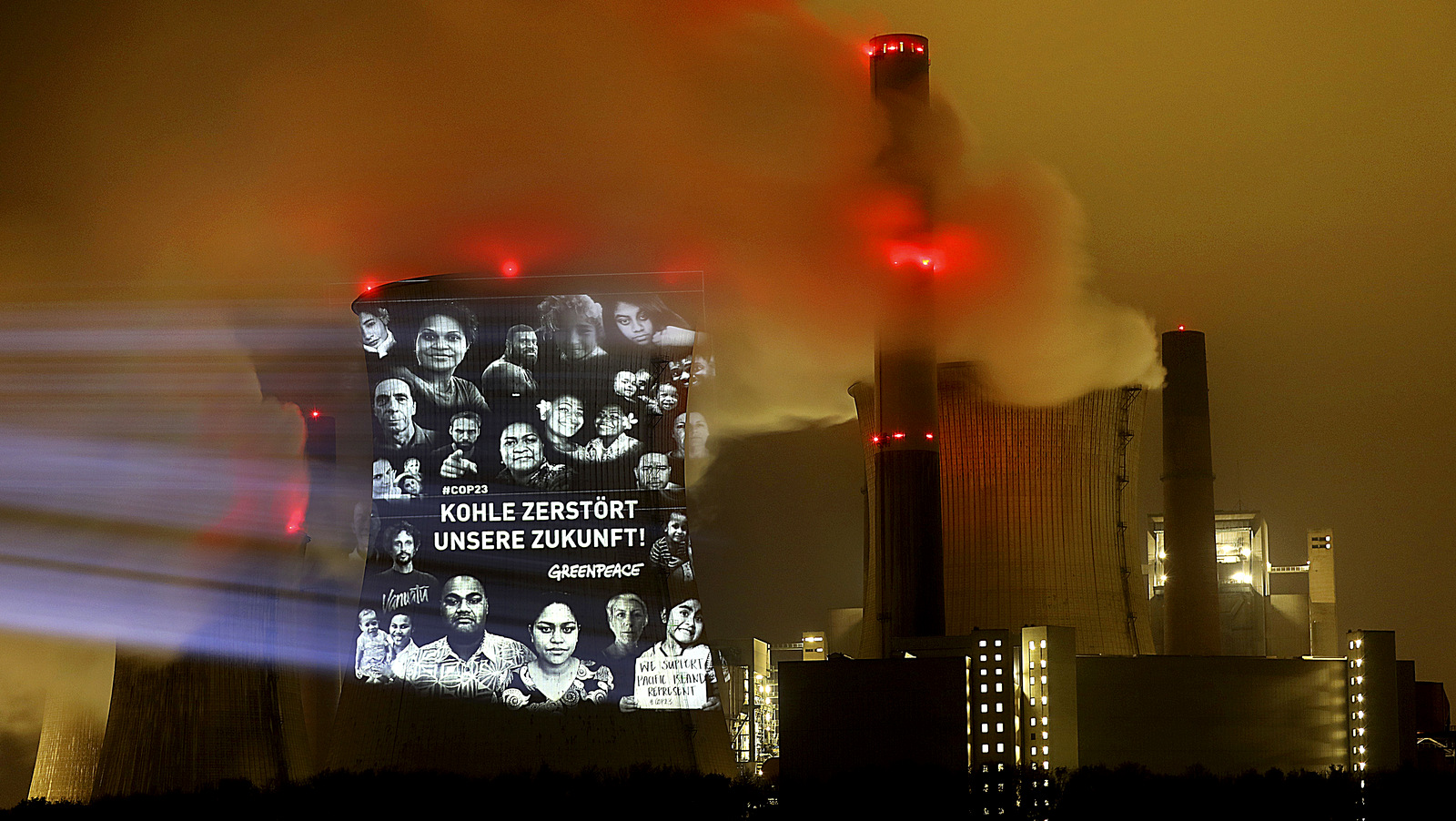 Greenpeace activists project the writing "Coal destroys our future" on the cooling tower of the lignite power plant Neurath near Grevenbroich, western Germany, Nov. 10, 2017 during the global climate meeting in nearby Bonn. (Oliver Berg/AP)