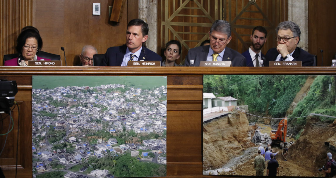 With photographs of hurricane damage on Puerto Rico and the U.S. Virgin Islands below them, Sen. Mazie Hirono, D-Hawaii, left, Sen. Martin Heinrich, D-N.M., Sen. Joe Manchin, D-W.Va., and Sen. Al Franken, D-Minn., attend a Senate Committee on Energy and Natural Resources hearing on hurricane recovery, Nov. 14, 2017, on Capitol Hill in Washington. (AP/Jacquelyn Martin)