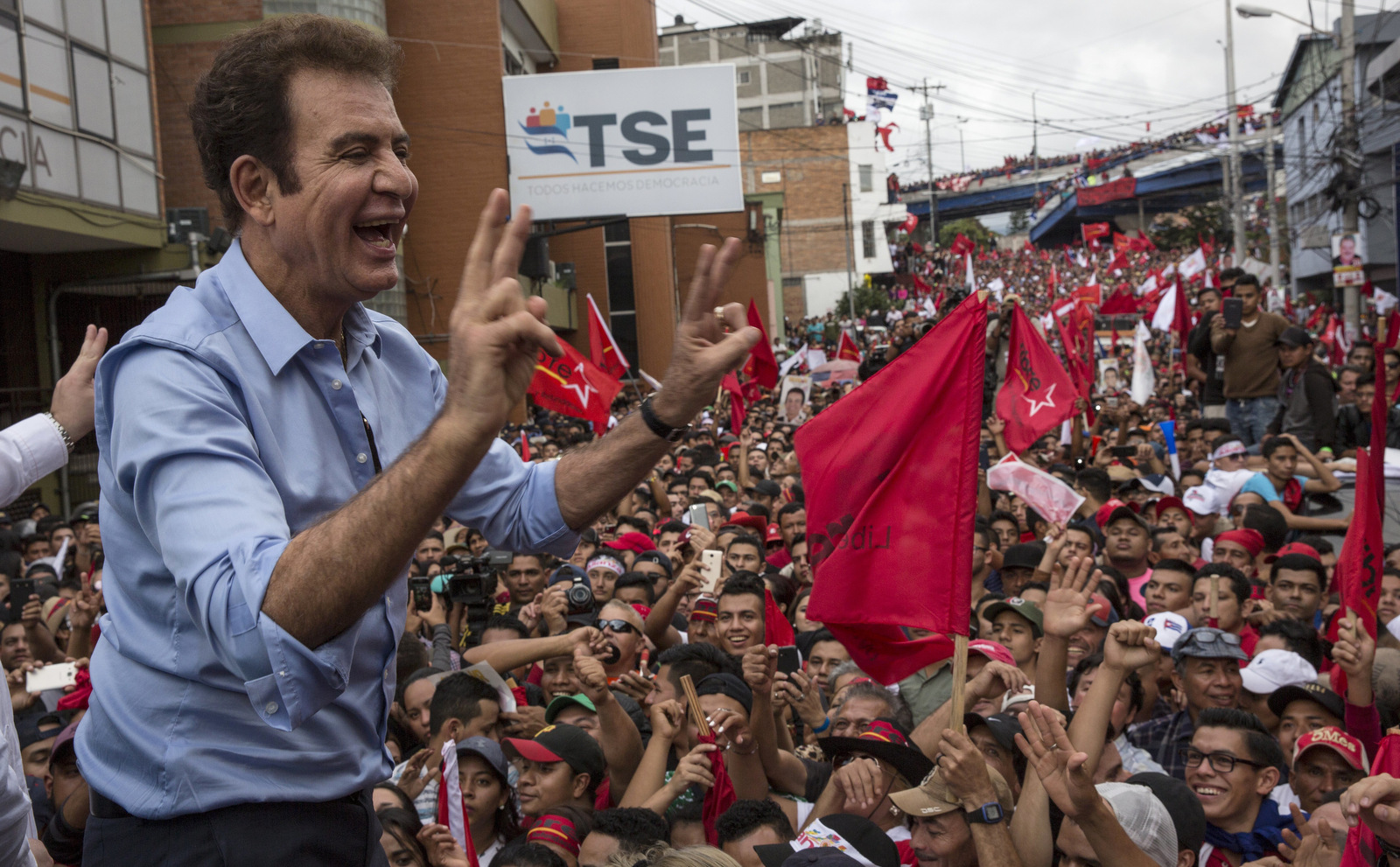 Salvador Nasralla greets supporters in front of the Supreme Electoral Tribunal in Tegucigalpa, Honduras, Nov. 27, 2017. Early results from Honduras' presidential election Monday showed Nasralla with a surprise lead over incumbent President Juan Orlando Hernandez, both of whom had claimed victory. (AP/Rodrigo Abd)