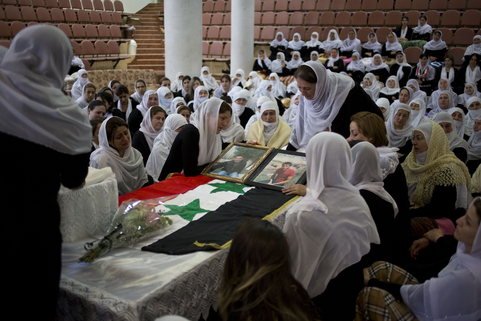 Druze women mourn the death of relatives, Thaer Mahmoud and Nazeah Mahmoud, two brothers who were killed in an Israeli airstrike after the Israeli military claim they were seen carrying a bomb near the border, in the Druze village of Majdal Shams, near the border with Syria, Israeli-controlled Golan Heights, April 27, 2015. (AP/Ariel Schalit)