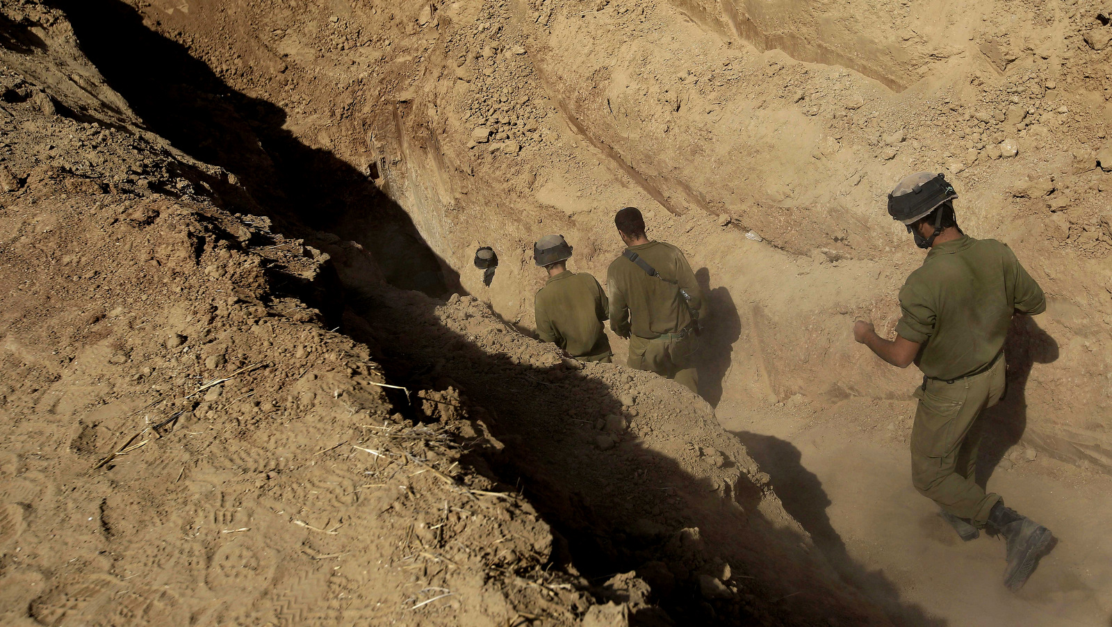 In this, Oct. 13, 2013 file photo, Israeli soldiers enter a tunnel discovered near the Israel Gaza border. (AP/Tsafrir Abayov)
