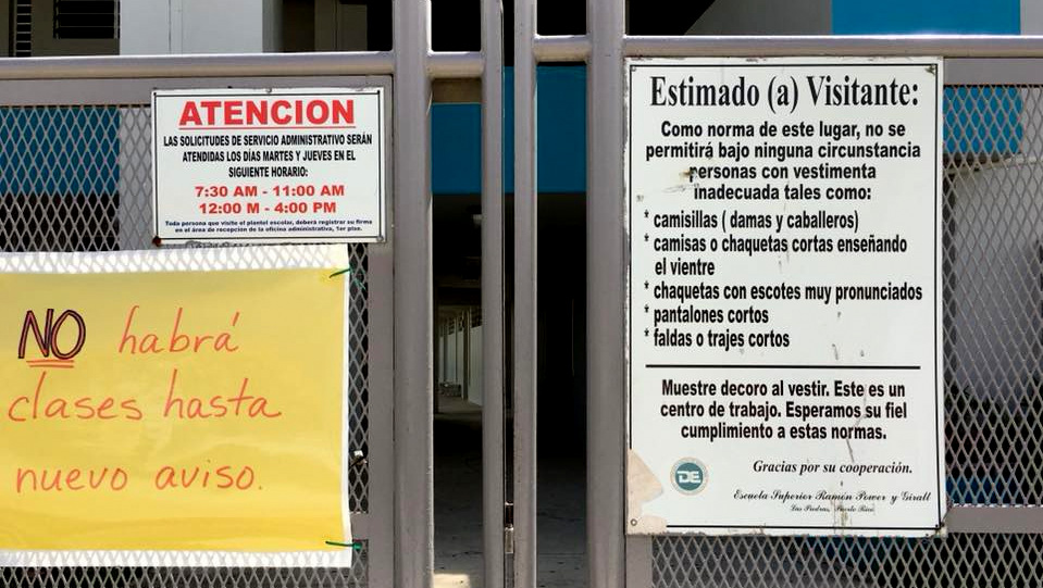 A sign informs residents that their local school is closed until further notice in the town of Las Piedras, Puerto Rico. (Déborah Berman-Santana)
