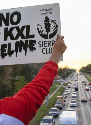 Opponents of the Keystone XL pipeline demonstrate on the Dodge Street pedestrian bridge during rush hour in Omaha, Neb., Wednesday, Nov. 1, 2017. The Nebraska Public Service Commission has until Nov. 23 to decide whether to approve or reject a proposed state route for the Keystone XL pipeline. (AP Photo/Nati Harnik)