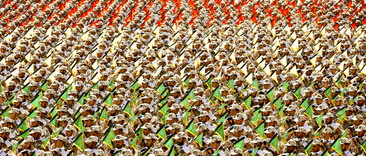 Members of the Iran's Revolutionary Guard march during an annual military parade marking the 34th anniversary of outset of the 1980-88 Iran-Iraq war, in front of the mausoleum of the late revolutionary founder Ayatollah Khomeini just outside Tehran, Iran, Sept. 22, 2014.