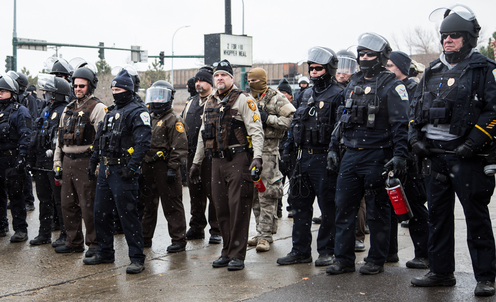 Police confront water protectors on Thanksgiving Day in Mandan, North Dakota, just north of the Standing Rock Sioux Reservation, after a symbolic feast on the town’s main thoroughfare. (Emma Fiala)