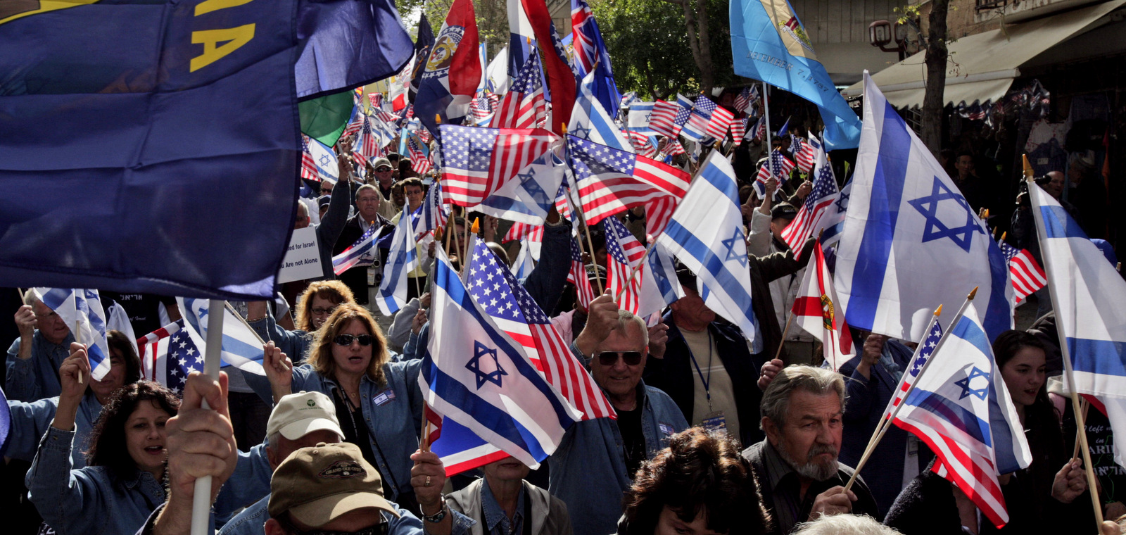 Evangelical Christians supporters of Israel hold US and Israeli flags as they march through Jerusalem. US Evangelist John Hagee, a Christian Zionist brought hundreds of backers on a solidarity trip to Israel, April 7, 2008. (AP/Peter Dejong)