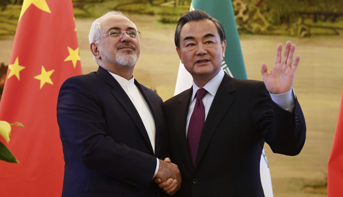 Iranian Foreign Minister Mohammad Javad Zarif, left, shakes hands with Chinese Foreign Minister Wang Yi after a joint press conference in Beijing, Dec. 5, 2016. (Greg Baker/AP)