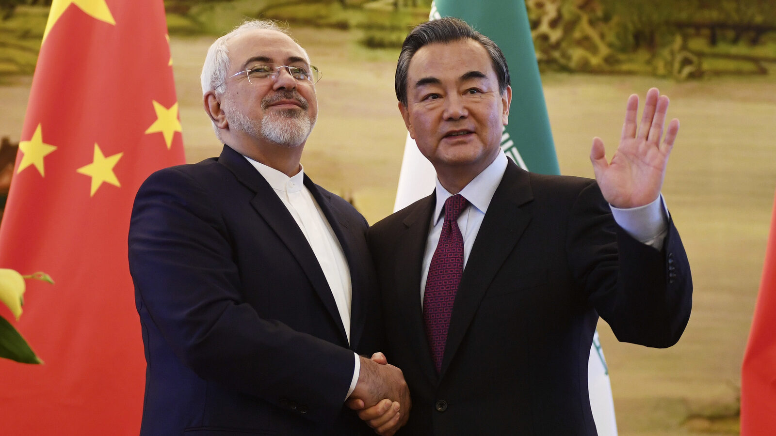 Iranian Foreign Minister Mohammad Javad Zarif, left, shakes hands with Chinese Foreign Minister Wang Yi after a joint press conference in Beijing, Dec. 5, 2016. (Greg Baker/AP)