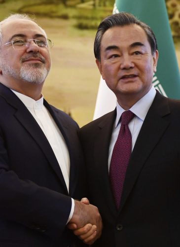 Iranian Foreign Minister Mohammad Javad Zarif, left, shakes hands with Chinese Foreign Minister Wang Yi after a joint press conference in Beijing, Dec. 5, 2016. (Greg Baker/AP)