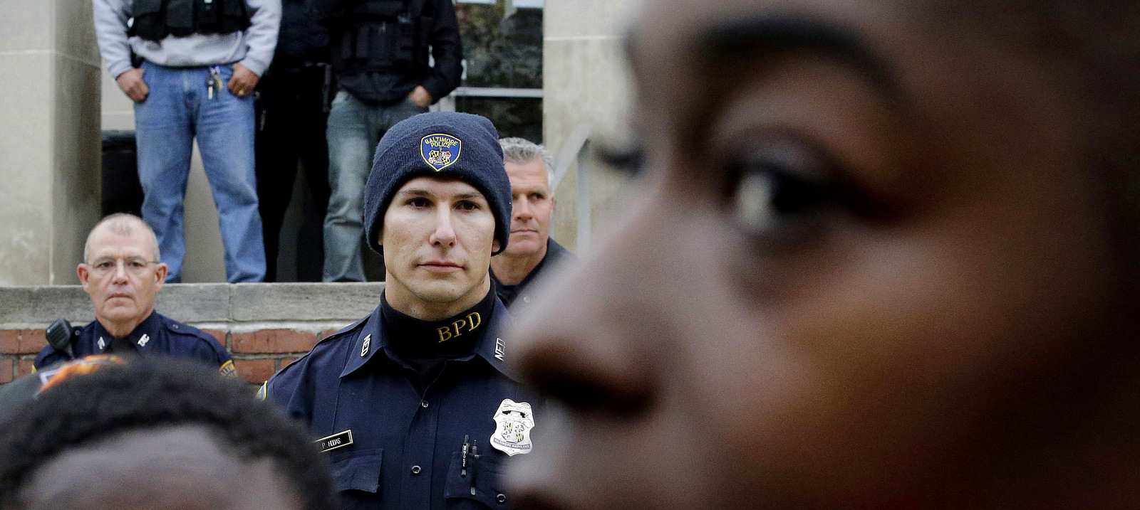 Members of the Baltimore Police Department stand guard outside the department's Western District police station during a protest in response to Freddie Gray's death in Baltimore. Baltimore's mayor and commissioner say they are eager and ready to change not only the culture of law enforcement, but the practice. (AP/Patrick Semansky)