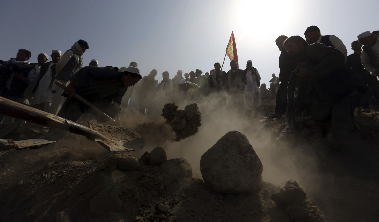 Afghan men bury a victim of a suicide attack at a Shia mosque in Kabul, Afghanistan, Oct. 21, 2017. ISIS is claiming responsibility for the attack that killed at least 39 and wounded at least 41. (AP/Rahmat Gul)