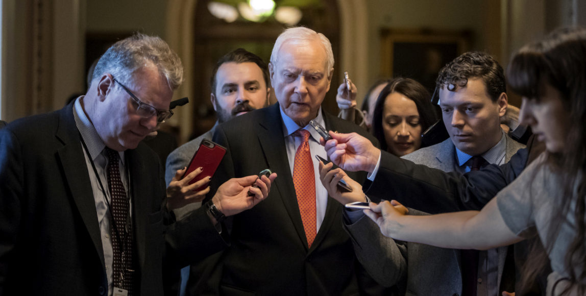 Reporters ask questions of Sen. Orrin Hatch, R-Utah, chairman of the tax-writing Finance Committee, as he walks to meet with Senate Majority Leader Mitch McConnell, R-Ky., on the GOP effort to overhaul the tax code, on Capitol Hill in Washington, Dec. 1, 2017. (AP/J. Scott Applewhite)