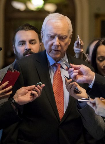 Reporters ask questions of Sen. Orrin Hatch, R-Utah, chairman of the tax-writing Finance Committee, as he walks to meet with Senate Majority Leader Mitch McConnell, R-Ky., on the GOP effort to overhaul the tax code, on Capitol Hill in Washington, Dec. 1, 2017. (AP/J. Scott Applewhite)