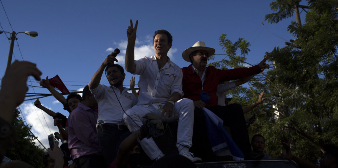 Opposition presidential candidate Salvador Nasralla, and former President Manuel Zelaya, greet supporters as they arrive for a protest near the institute where election ballots are stored in Tegucigalpa, Honduras, Sunday, Dec. 3, 2017. Residents of Honduras' capital are bracing for more demonstrations after a night of pot-banging protests over the long-delayed vote count in last week's presidential elections. Nasrralla is calling for a re-do of the election.(AP/Rodrigo Abd)