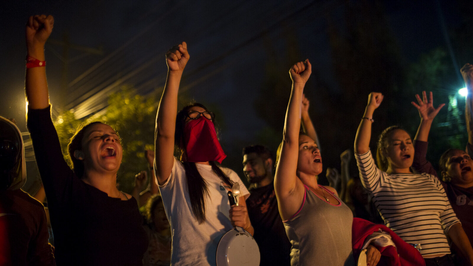 Protestors shout slogans during a government imposed dawn-to-dusk curfew in Tegucigalpa, Honduras, late Sunday, Dec. 3, 2017. Honduran electoral authorities have restarted the long-delayed count of ballots from last weekend's presidential election amid protests by supporters of opposition candidate Salvador Nasralla, who is calling for a re-do of the vote. (AP/Rodrigo Abd)